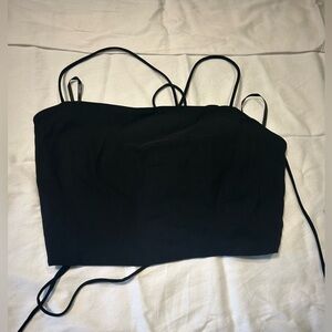 Black medium crop top with spaghetti straps and lace up back